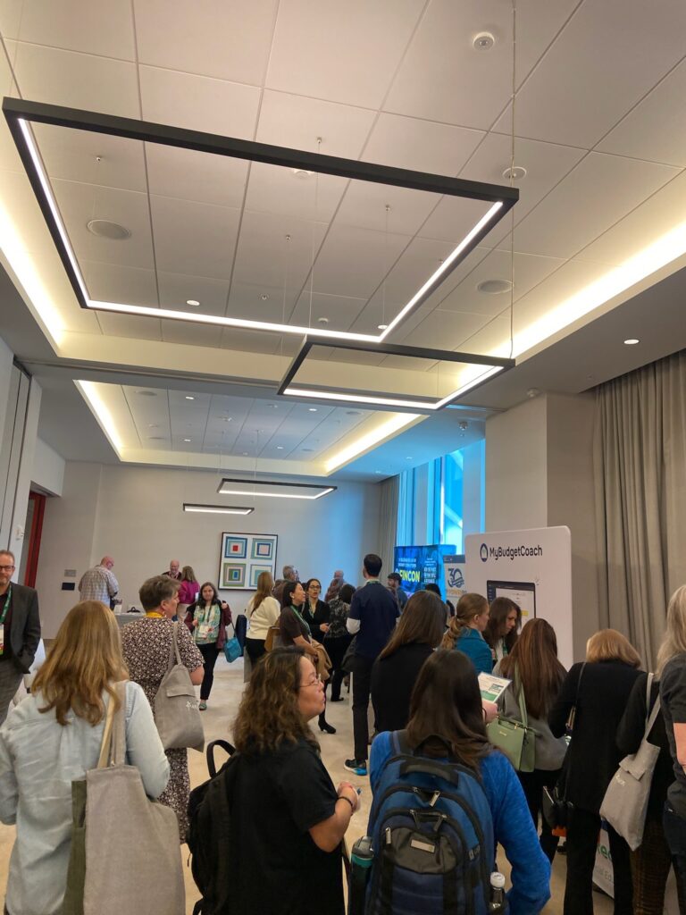 Lots of people walking around the AFCPE Symposium exhibit hall