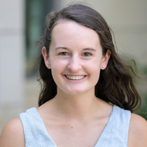 Headshot of Taylor Patskanick smiling in front of a blurred background.