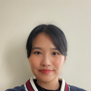 This is the headshot of award winner Hanna Yu. She is smiling demurely in front of a beige background.